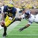 Michigan quarterback Devin Gardner dives in for a touchdown past Northwestern safety Ibraheim Campbell in the first quarter at Michigan Stadium on Saturday. Melanie Maxwell I AnnArbor.com